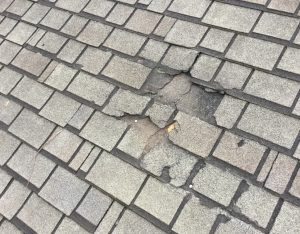 Leak in roof from damaged and cracked shingles