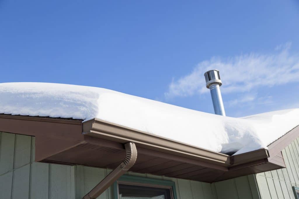 Close-up of deep snow on a house roof after a blizzard.